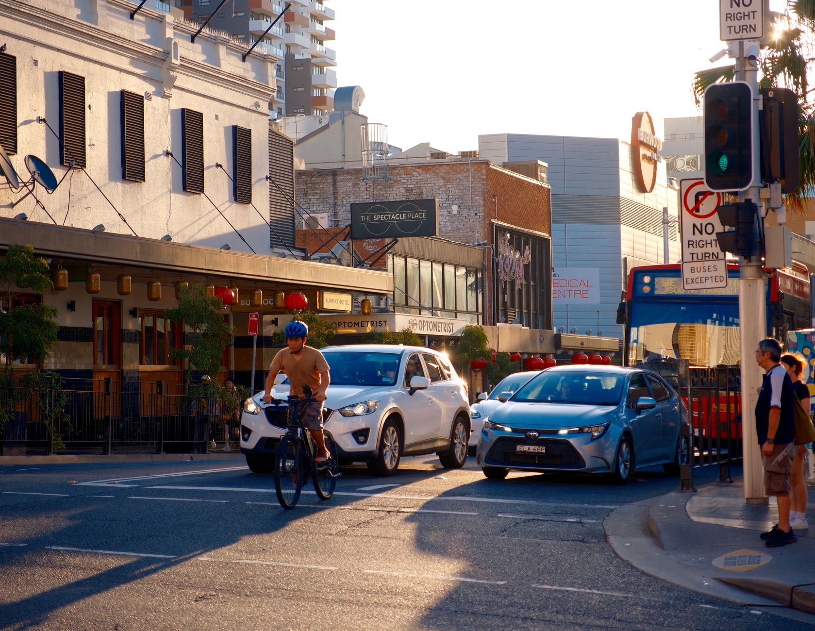 A professional working at a desk in a bright office in a regional Australian town, engaging with team members.